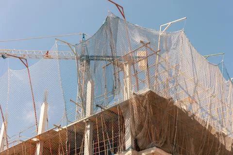 Captivating image of construction site under a bright sky, featuring crane Stock Photos