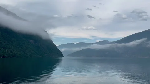 This captivating image features fog rolling over majestic mountains Stock Footage 314095746