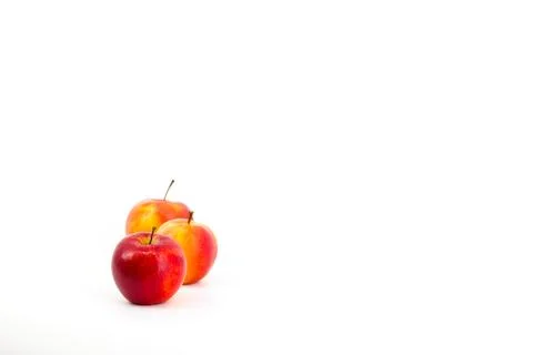 A captivating image featuring vibrant red apples set against a pristine whi.. Stock-Fotos