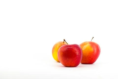 A captivating image featuring vibrant red apples set against a pristine whi.. Stock Photos