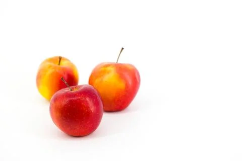 A captivating image featuring vibrant red apples set against a pristine whi.. Stock Photos
