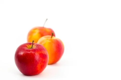 A captivating image featuring vibrant red apples set against a pristine whi.. Stock-Fotos