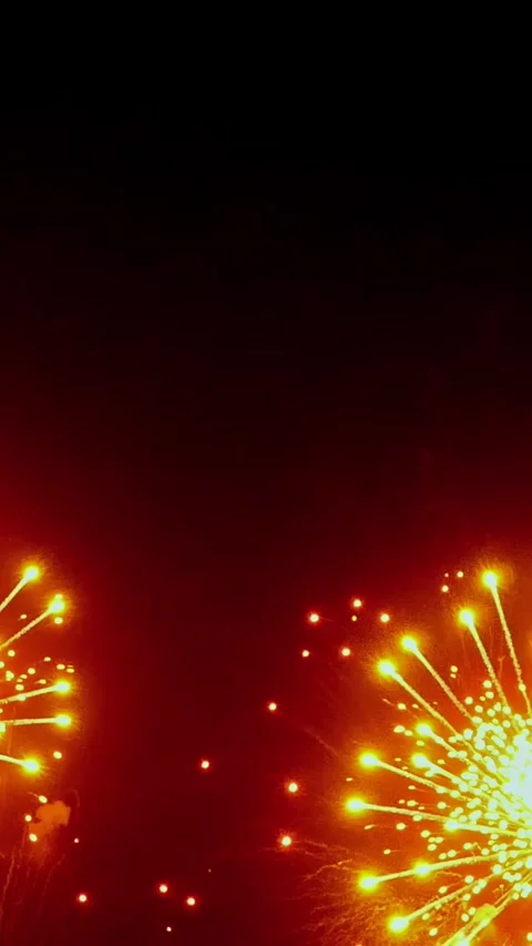 Captivating night sky filled with vibrant fireworks over the city skyline Stock Footage 299460291