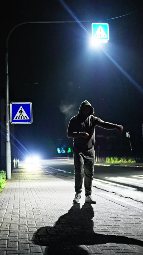 A captivating nighttime urban scene featuring a lone The athlete is warming up Video stock 306978038