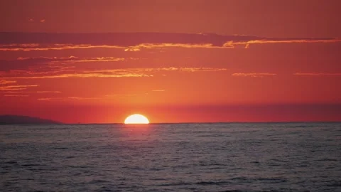 A captivating ocean sunset featuring a vivid red and orange sky in the Stock Footage 281021338