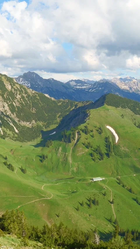 Captivating Panoramic Views of Rolling Hills, Snow-Capped Peaks, and Vibrant Stock Footage 309228786