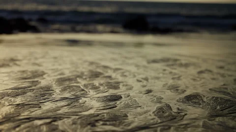 Captivating Patterns on a Serene Beach: A Natural Display of Waves and Sand Video stock 310061183