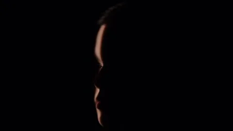 Captivating Portrait with Dramatic Shadow Play and Light Beam Stock Footage 310497704