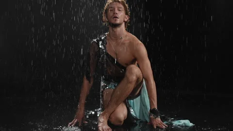 Captivating Rain Soaked Pose Illuminated in Stunning, Dramatic Lighting Stock Footage 313629299