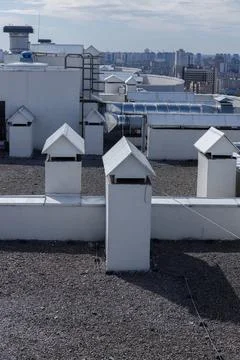 A Captivating Rooftop View: Unique Chimneys and Modern Urban Skyline in the Stock Photos