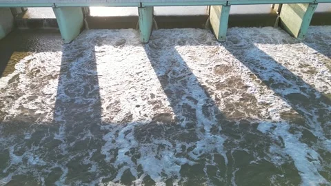 Captivating scene of river water rushing through dam gates, highlighting Video stock 335890626