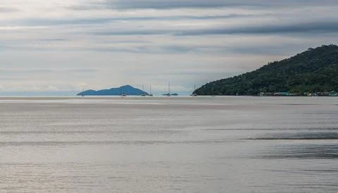 A captivating seascape showcasing dramatic clouds over a stunning island view in Stock Photos