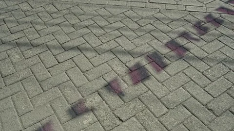 Captivating shadows of festive pennants cast on an outdoor paved block ston.. Stock-Footage 344358078