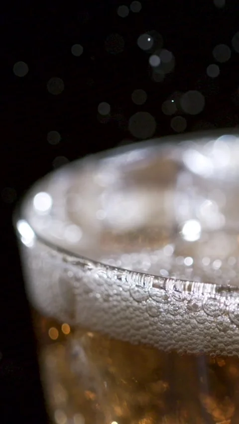 Captivating Slow Motion of Bubbles Rising in a Refreshing Glass of Soda Stock Footage 336824483