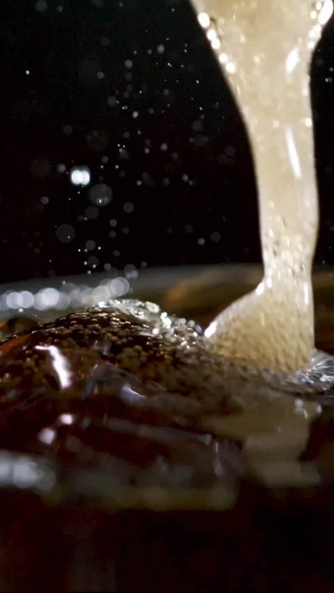 Captivating Slow Motion of Cola Bubbles and Splashes Showcasing Detailed Stock Footage 336824020