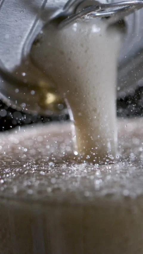 Captivating Slow Motion of Frothy Beer Pouring Into a Glass With Stunning Detail Stock Footage 336824321