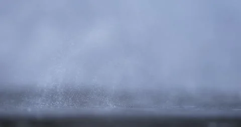 Captivating Slow Motion of Raindrops Splashing and Creating Ripples on Water Stock Footage 336824003