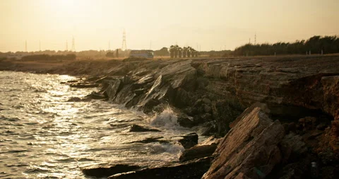 A Captivating Spectacle: Waves of the Sea Embrace the Sun's Last Glow Vídeos de archivo 244332238