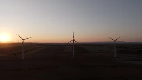 Captivating sunset illuminating a rotating wind turbine in a serene field Stock-Footage 300630267