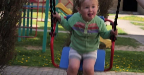 Captivating Swing Ride: Close-Up of a Red and Blue Swing in Motion Vídeos de archivo 242458404