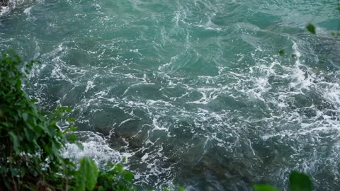 Captivating Turquoise Waters: Dynamic Swells and Gentle Waves Lapping Against Stock Footage 310058793