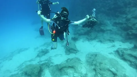 A captivating underwater scene featuring multiple scuba divers Stock Footage 327401250