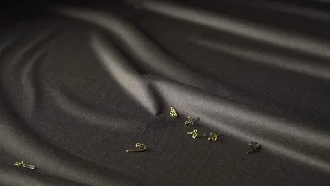 Captivating Video of Falling Pins Against a Rich Black Fabric Background Stock Stock Footage 310248622