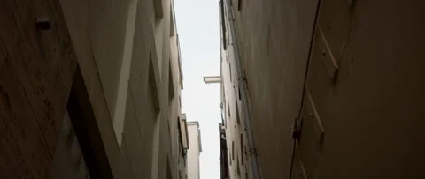 Captivating View Between Tall Buildings Found in an Urban Alleyway Setting With Stock Footage 301467997
