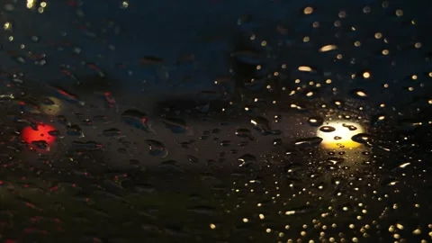 Captivating view of blurred car lights through rain-drenched window Stock Footage 321665830