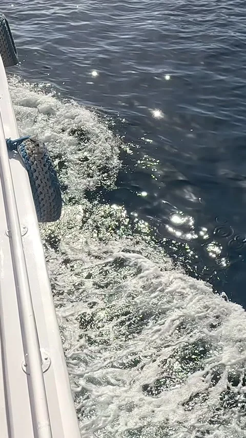 Captivating View of Gentle Waves and Sunlit Sparkles from a Boat's Side, 库存影片 331278318