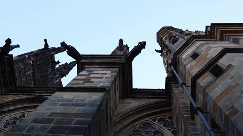 A captivating view of Gothic gargoyles and buttresses against the sky, showcasin Stock Footage 294781305