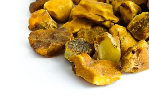 A captivating view of raw Polish Baltic amber on white, showcasing its text.. Stock Photos