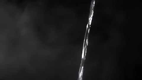 A Captivating Water Stream Set Against a Dark and Mysterious Background That Stock-Footage 312013511