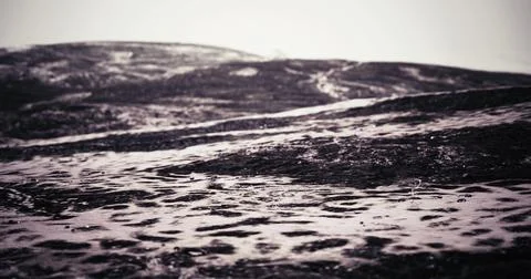 Captivating waves create textures on the shoreline at dusk Stock Illustration