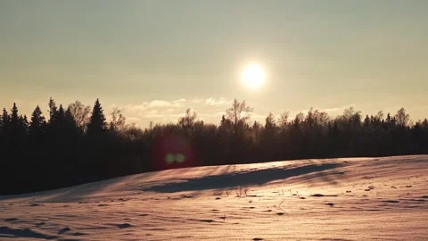 Captivating Winter Sunset Over a Tranquil Snowy Landscape 動画素材 331756675