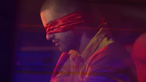 Captive man blindfolded, sitting in the backseat of car Stock Footage 109273957
