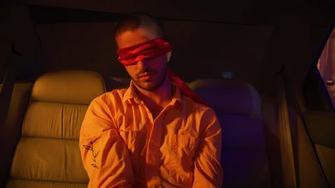 Captive man with hands tied up in backseat of car Stock Footage 108947339