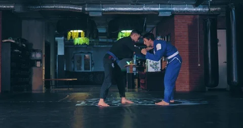 Capture the enemy for a kimono and throw. Young guys in a kimono are fighting in Stock Footage 121013883