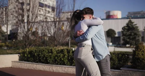 Capture of an exuberant moment with a young man lifting a woman in a joyful hug Stock Footage 311890686