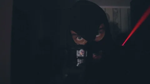 Capture group in masks with guns with laser sights enters the house closeup Stock Footage 103122762