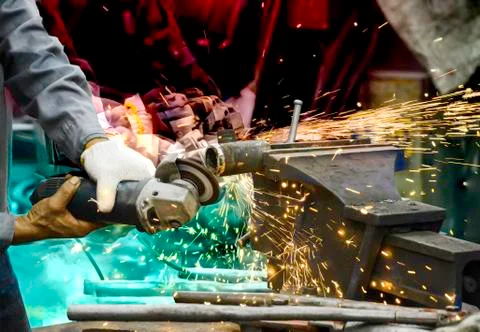 Capture motion of worker are grinding steel plate, Electricity spark from cha Stock Photos