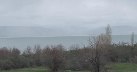 Capture the panoramic view of mist-shrouded Lake Sevan in Armenia, where the Stock Footage 252467105