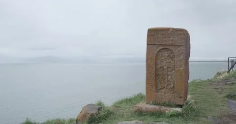 Capture the tranquil beauty of a stone slab adorned with a cross, enveloped by Stock Footage 252467013