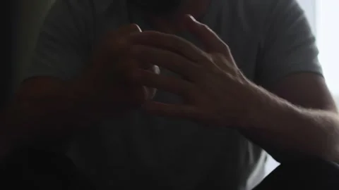 Captured in a dark setting, a man's hands express his internal turmoil and .. Stock Footage 273041136