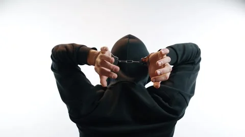 Captured guilt: hands cuffed behind a head 스톡 동영상 312473425