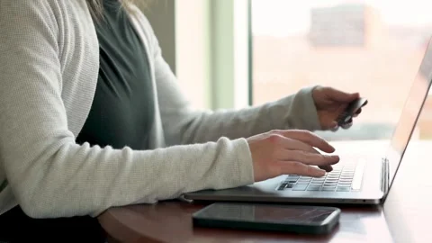 Captured in a modern office setting, this image shows a professional woman ho Видео 274516632