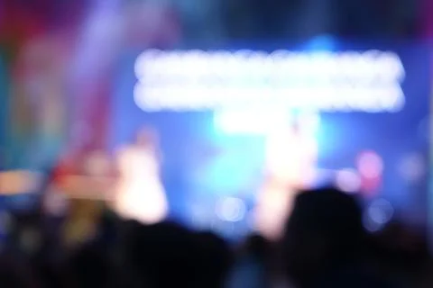 Captured in motion, a crowd of concert-goers is seen in very blur of colorf.. Stock Photos