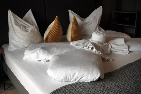 Captures nice arranged stack of neatly rolled towels in old hotel room on woo Stock Photos