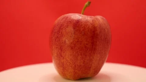 Captures a stunning apple against a vibrant red background highlighting natures Stock Footage 328634455
