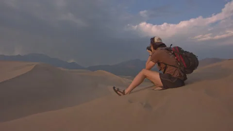 Capturing the beauty of desert dunes during golden hour while photography in Stock Footage 288561682